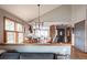 Bright dining room area featuring wood flooring, access to kitchen, and ample natural light at 3 Pinyon Pine Rd, Littleton, CO 80127