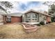 Charming home featuring a brick and siding exterior, complemented by a well-maintained front yard with landscaped flowerbeds at 3 Pinyon Pine Rd, Littleton, CO 80127