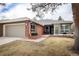 Charming single-story home featuring a two-car garage, brick facade, and well-maintained landscaping at 3 Pinyon Pine Rd, Littleton, CO 80127