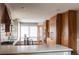 Modern kitchen with wood cabinets, stainless steel appliances, and white quartz countertops at 3 Pinyon Pine Rd, Littleton, CO 80127
