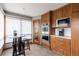 A bright eat-in kitchen features a modern design with wood cabinetry and stainless steel appliances at 3 Pinyon Pine Rd, Littleton, CO 80127