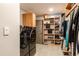 Laundry room featuring modern appliances and built-in shelving perfect for organizing and easy storage at 3 Pinyon Pine Rd, Littleton, CO 80127