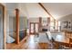 View of the dining area, fireplace, and access to the kitchen in a bright and airy home at 3 Pinyon Pine Rd, Littleton, CO 80127