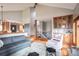 Spacious living room with a view of the staircase and custom-built in bar at 3 Pinyon Pine Rd, Littleton, CO 80127
