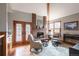 Cozy living room with a brick fireplace and comfortable seating area with wood floors at 3 Pinyon Pine Rd, Littleton, CO 80127