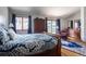 Main bedroom featuring a large bed, wood floors, and access to the backyard through sliding doors at 3 Pinyon Pine Rd, Littleton, CO 80127