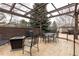 Outdoor patio with a pergola, black metal table and chairs, and a fire pit at 3 Pinyon Pine Rd, Littleton, CO 80127