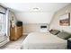 Comfortable bedroom featuring neutral walls, wood-look floors, and a large dresser for ample storage at 2565 Pierce St, Lakewood, CO 80214