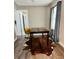 Dining area features a wood table, cowhide rug, and natural light, creating an inviting space for meals at 2565 Pierce St, Lakewood, CO 80214