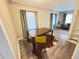 View of a modern dining room with hardwood floors, a wooden table, and a stylish yellow chair at 2565 Pierce St, Lakewood, CO 80214