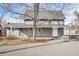 Charming two-story home with gray painted brick, white trim, and a well-maintained front yard and an adjacent two-car garage at 2565 Pierce St, Lakewood, CO 80214