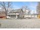 Charming two-story home with gray painted brick, white trim, and a large parking area for vehicles at 2565 Pierce St, Lakewood, CO 80214