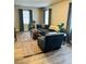 Cozy living room featuring a blue sofa, wood coffee table, patterned rug, and natural light from the windows at 2565 Pierce St, Lakewood, CO 80214