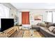 Comfortable living room featuring a large sectional sofa, stylish decor, and natural light from windows at 2565 Pierce St, Lakewood, CO 80214