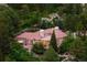 Expansive aerial view of luxurious home nestled amongst lush trees at 392 Starmine Pl, Castle Rock, CO 80108