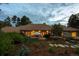 Expansive backyard and patio featuring an umbrella table setting and lush foliage at 392 Starmine Pl, Castle Rock, CO 80108