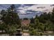 Enjoy this view surrounded by trees from the backyard seating area at 392 Starmine Pl, Castle Rock, CO 80108