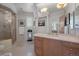 Bright bathroom boasts a glass enclosed shower, a vanity with custom cabinets, and natural light at 392 Starmine Pl, Castle Rock, CO 80108