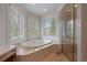 Bright bathroom boasts a soaking tub with natural light and a glass enclosed shower at 392 Starmine Pl, Castle Rock, CO 80108