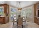 Bright dining area with a round table, shuttered windows and a view of the backyard at 392 Starmine Pl, Castle Rock, CO 80108