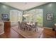 Elegant dining room featuring large windows, hardwood floors and chandelier lighting at 392 Starmine Pl, Castle Rock, CO 80108