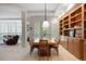 Bright dining room with wood table, stylish chairs, and custom built-in shelving and cabinets at 392 Starmine Pl, Castle Rock, CO 80108