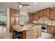 Spacious kitchen with an island, stainless appliances, stone countertops and custom cabinets at 392 Starmine Pl, Castle Rock, CO 80108