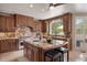 Gourmet kitchen features a granite island, custom cabinets, and stainless steel appliances at 392 Starmine Pl, Castle Rock, CO 80108