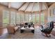 Bright living room with beam ceiling, hardwood floors and a cozy fireplace at 392 Starmine Pl, Castle Rock, CO 80108