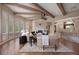 Spacious living room with hardwood floors, beam ceiling, fireplace and staircase access at 392 Starmine Pl, Castle Rock, CO 80108