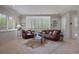 Spacious living room filled with natural light, comfortable leather furniture, and stylish décor at 392 Starmine Pl, Castle Rock, CO 80108