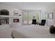 Bright primary bedroom featuring fireplace, plush carpet and french doors to outdoor deck at 392 Starmine Pl, Castle Rock, CO 80108