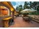 Rear patio features an outdoor kitchen, dining area, and lush landscaping at 392 Starmine Pl, Castle Rock, CO 80108