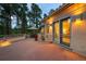 Outdoor patio with ample seating, surrounded by trees and landscape lighting at 392 Starmine Pl, Castle Rock, CO 80108