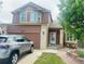 Two-story home with brick accents, attached garage, with a well-kept lawn and front porch at 20410 Kelly Pl, Denver, CO 80249