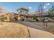 Exterior of the community clubhouse showing walkway and benches, enhanced by mature trees and landscaping at 14091 E Marina Dr # 308, Aurora, CO 80014