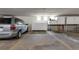 Assigned garage parking space with a car and storage in a well-lit and secure area at 14091 E Marina Dr # 308, Aurora, CO 80014