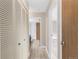 Hallway with access to the bathroom, featuring a full-length mirror and storage at 14091 E Marina Dr # 308, Aurora, CO 80014