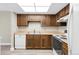 Functional kitchen featuring white appliances, and dark wood cabinetry at 14091 E Marina Dr # 308, Aurora, CO 80014