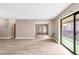 Bright living room with wood-look floors and sliding glass doors to a private balcony at 14091 E Marina Dr # 308, Aurora, CO 80014