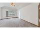 Bright bedroom featuring neutral carpet, a large window, and trim at 13515 Milwaukee Ct, Thornton, CO 80241
