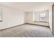 Bedroom with neutral carpet, a large window, and trim at 13515 Milwaukee Ct, Thornton, CO 80241