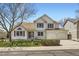 Charming two-story home featuring a three-car garage, green lawn, and beautiful curb appeal on a sunny day at 13515 Milwaukee Ct, Thornton, CO 80241