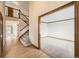 Bright foyer with hardwood floors, staircase, and entryways to carpeted rooms creating an inviting entrance at 13515 Milwaukee Ct, Thornton, CO 80241