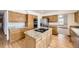 Updated kitchen with granite countertops, stainless steel appliances, and a center island for meal preparation at 13515 Milwaukee Ct, Thornton, CO 80241