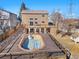 Large wooden deck and oval pool with stairs leading to the backyard at 3948 S Halifax St, Aurora, CO 80013