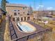 Large wooden deck with oval pool surrounded by brown two-story home at 3948 S Halifax St, Aurora, CO 80013