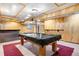 Basement with a pool table, bar, and panelled walls; great for entertaining at 3948 S Halifax St, Aurora, CO 80013