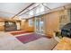 Spacious basement with a stone fireplace, wet bar, and walkout to the outdoor area at 3948 S Halifax St, Aurora, CO 80013