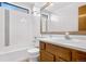 Bright bathroom with white tile, tub, and single sink vanity, perfect for relaxation at 3948 S Halifax St, Aurora, CO 80013